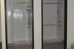 Empty shower stalls in the Messiah gym locker room