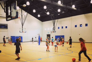 Children playing basketball in the Messiah gym